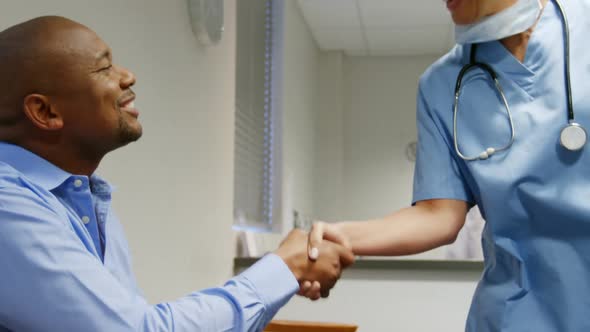 Female doctor shaking hands with patient