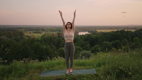 Young Woman Practicing Yoga in the Nature