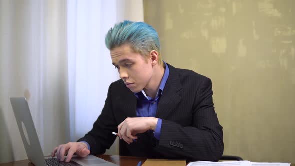 Young Businessman Working in Laptop Smoking Ecigarette Office Worker