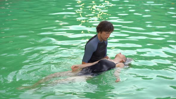 A Master of Watsu Massage Conducts a Massage in the Pool