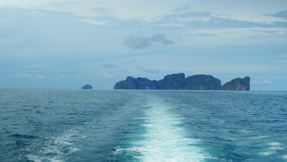 White bubbles and splashes of waves on the stern of the ferry ship.