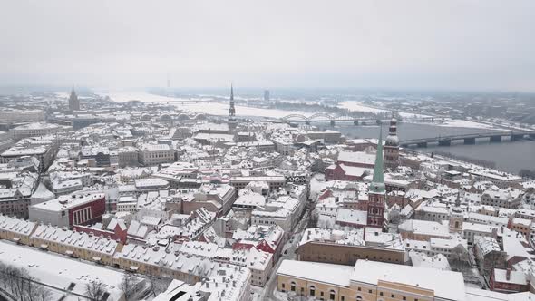 Aerial Flight Revealing Old City of Riga  Vecriga Covered in Snow