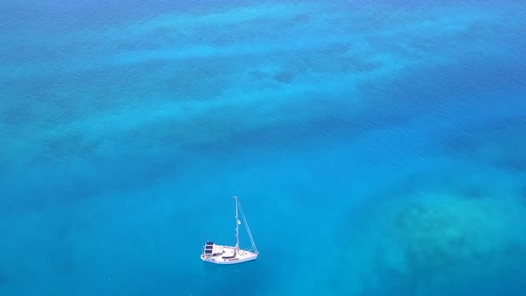 Drone aerial texture of island beach by blue water and sand background