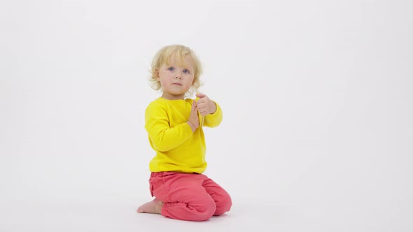 Funny Little Toddler Using Smartphone Shows Screen to Parents White Background