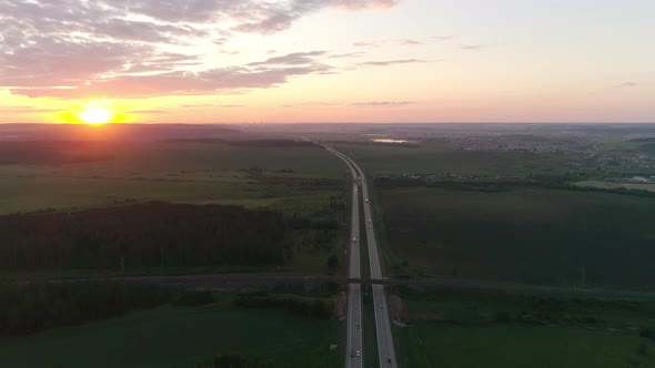Aerial view of evening highway and fields at sunset 06