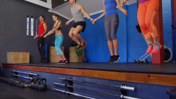 Group of people performing skipping exercise