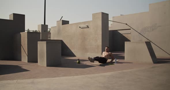 Sportsman Doing Abs Exercise on Sports Ground