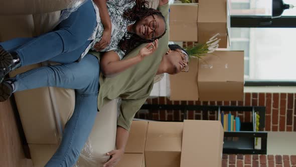 Vertical Video African American Partners Unpacking Living Room Couch