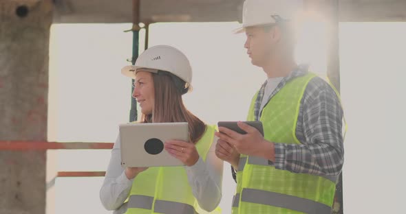 Engineers Designers Stand on the Roof of the Building Under Construction and Discuss the Plan and