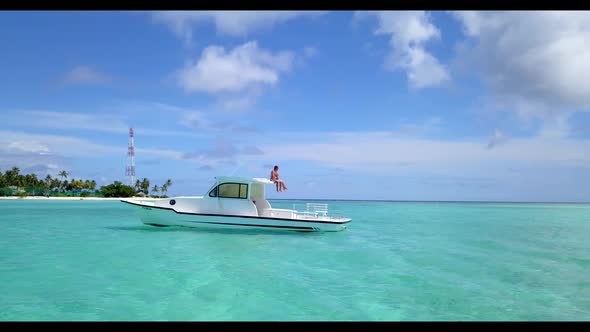 Man and woman relax on idyllic island beach voyage by blue water with white sand background of the M