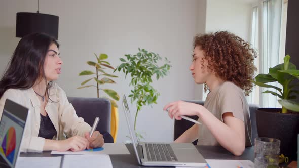 Professional Indian Teacher Manager or Mentor Helping Latin Student New Employee Teaching Intern