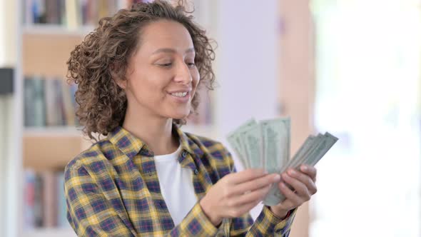 Portrait of Happy Mixed Race Woman Counting Dollars