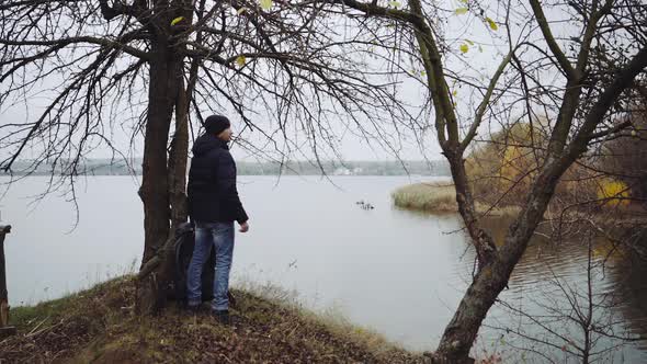 Man tourist standing near river