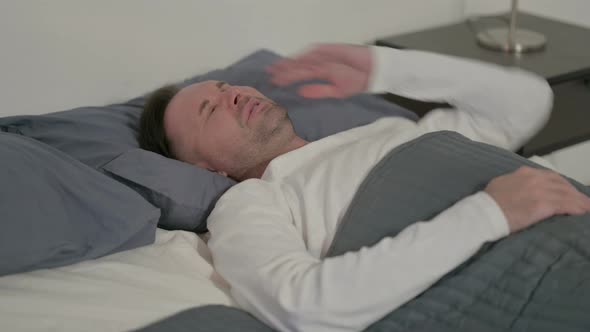 Casual Man Having Headache While Sleeping in Bed