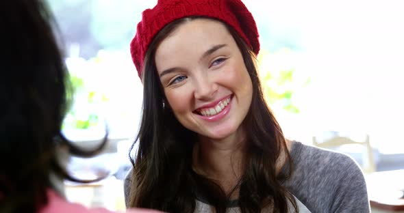 Woman smiling while interacting with friend