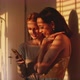 Two models looking at the phone - VideoHive Item for Sale