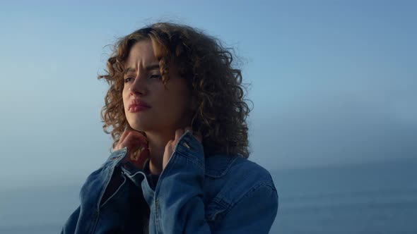 Sad Girl Standing on Ocean Beach