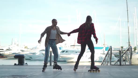 Happy friends riding roller skates together