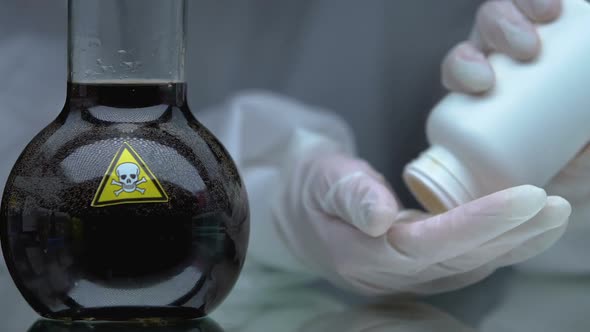 Scientist Showing Antidote Pills Near Flask With Poisonous Liquid, Medication