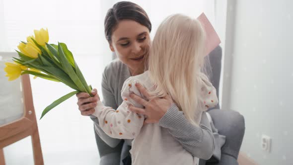 Elementary age girl about to hand in flowers to her mother. Shot with RED helium camera in 8K.