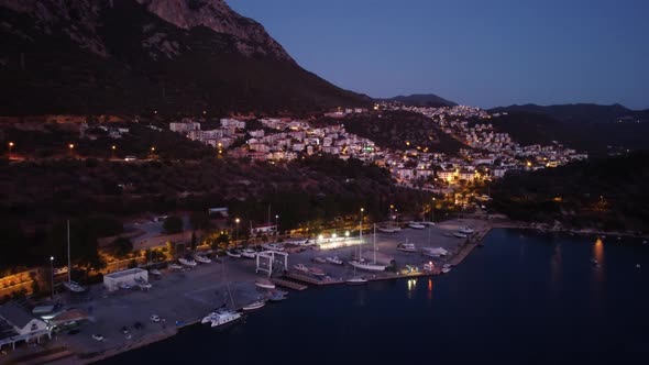 Drone Footage of Touristic Kas Town in Turkey with Houses on the Mountain at Summer Evening