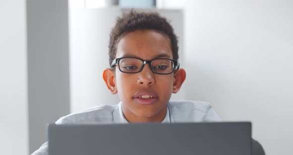 Small African Manager Working on Laptop in Office