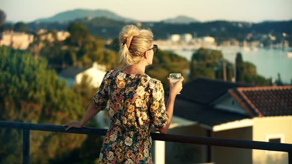 Woman Drinking White Wine On Holidays Vacation. Romantic Evening Enjoying Wineglass.