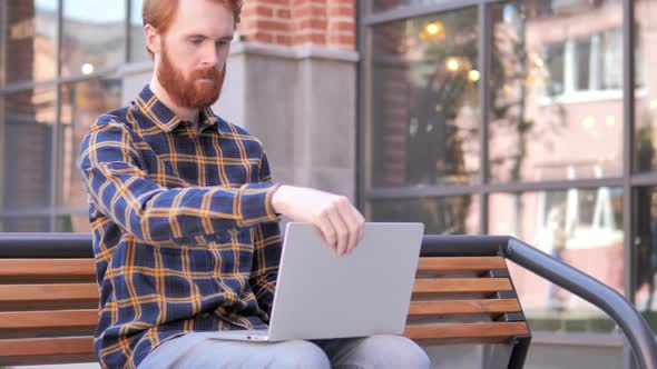 Redhead Beard Young Man Coming and Sitting on Bench to Use Laptop