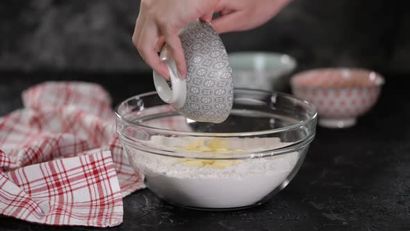 Preparation of Ingredients for Baking. Female Hands Add Butter To the Bowl with Flour