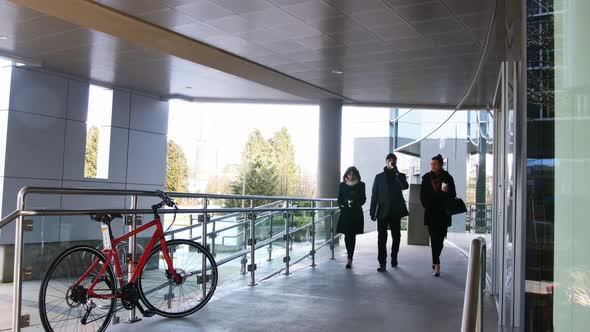 Executives having coffee while walking