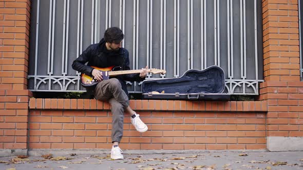 The Guy Playing on the Giutar Outdoor
