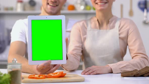 Pretty Family Couple Holding Green Screen Tablet and Showing Thumbs-Up, Blogging