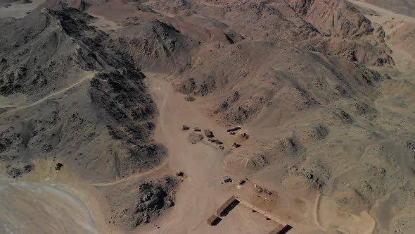 Top view of the Sahara desert, desert mountains. Wooden Bedouin houses. Sands.