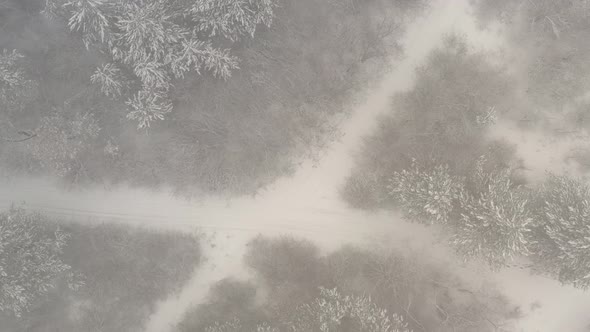 Descending over the snowed crossroad 4K aerial video