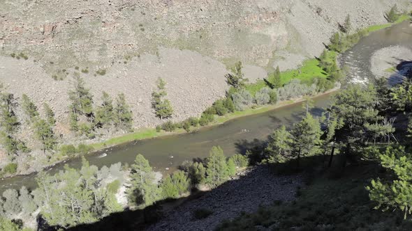 Broken Crumbled Rocks Spilling From the Narrow Canyon Slope Ridge Towards the Deep Valley Floor