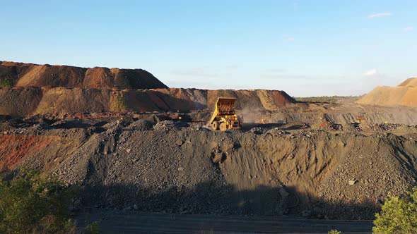 A Large Truck Unloads Iron Ore in a Quarry