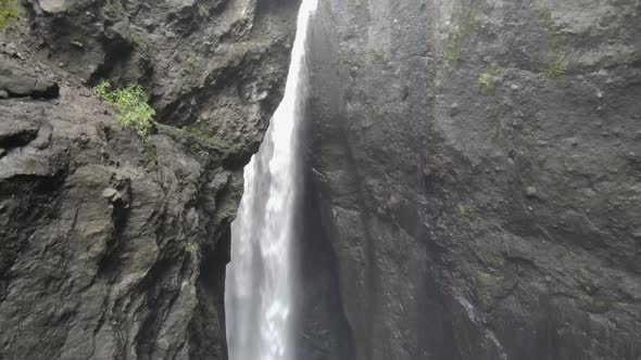 Drone footage of a waterfall in a tight canyon in the Cirque of Mafate at the Reunion island.