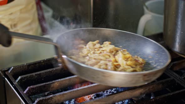 Slow motion of shawarma cooking in a frying pan
