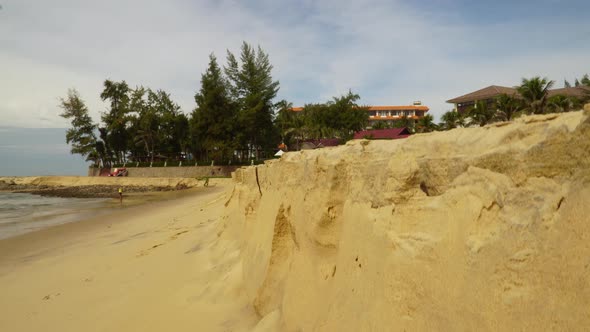 Pan tilt up shot of beach erosion, Vietnam