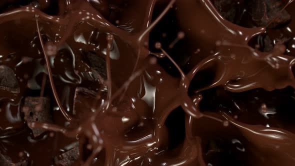 Super Slow Motion Shot of Raw Chocolate Chunks Falling Into Melted Chocolate at 1000 Fps