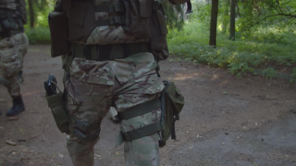 Closeup of Armed Soldier Using Assault Rifle with Collimator Sight