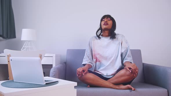 African American Woman Practising Breathing Exercises for Relaxation 