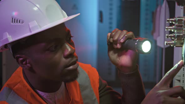 Male Technician Inspecting Data Center Equipment