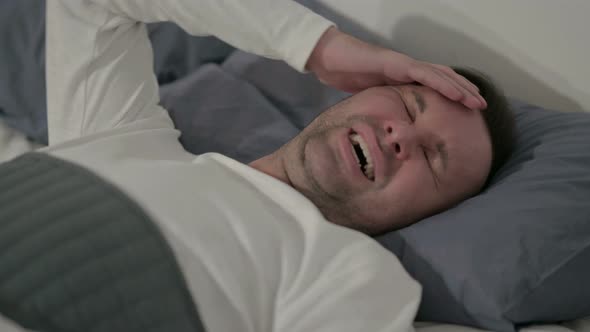 Close Up Casual Man Having Headache While Sleeping in Bed