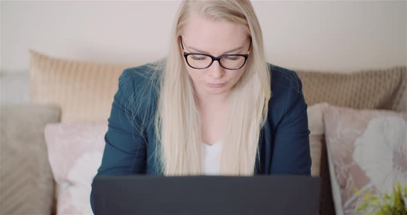 Female Entrepreneur Using Laptop In Office