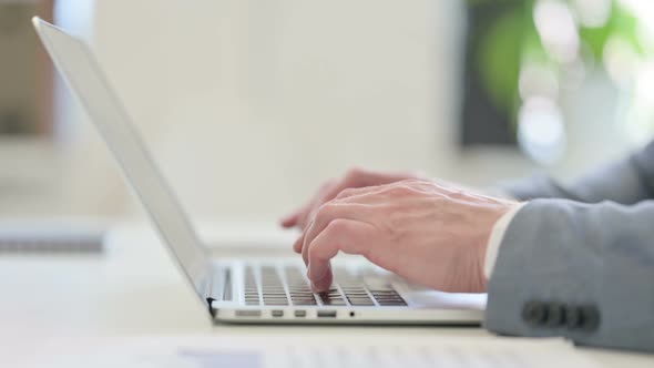 Close Up of Businessman Typing on Laptop