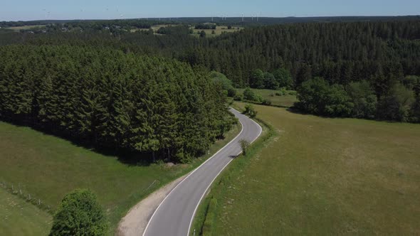 Road in nature reserve Eifel in Germany near Kalterherberg, hills and forest