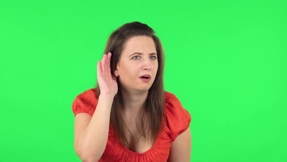 Portrait of Girl Holding Hand Near Ear Trying Listen To Interesting News Expressing Communication