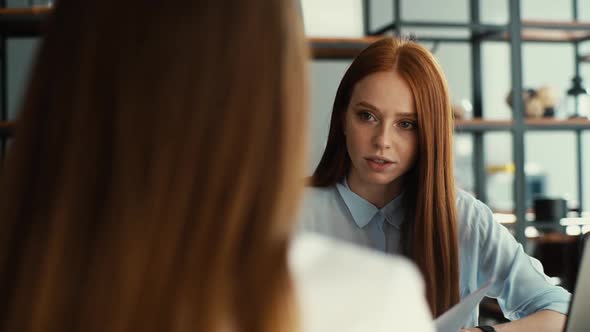 Back View of Female Applicant During Job Interview Talking to Young Woman Employers