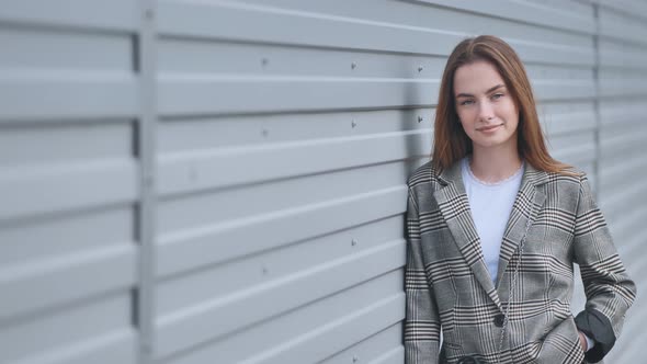 Portrait of a Young Girl in a Blazer By a Wall on the Street